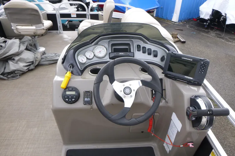 Slide: The Image of 2021 Sun Tracker Fishin' Barge 20 DLX dashboard with steering wheel and navigation system. - 8