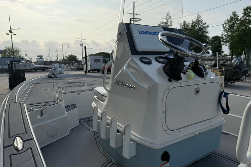 Slide: The Image of 2023 Skeeter SX240 boat console with steering wheel and navigation equipment. - 11