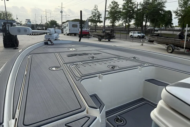 Slide: The Image of 2023 Skeeter SX240 boat deck with sleek design and modern features, parked outdoors. - 12