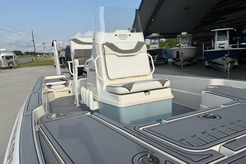 Slide: The Image of 2023 Skeeter SX240 boat interior with seating and console, displayed outdoors. - 14