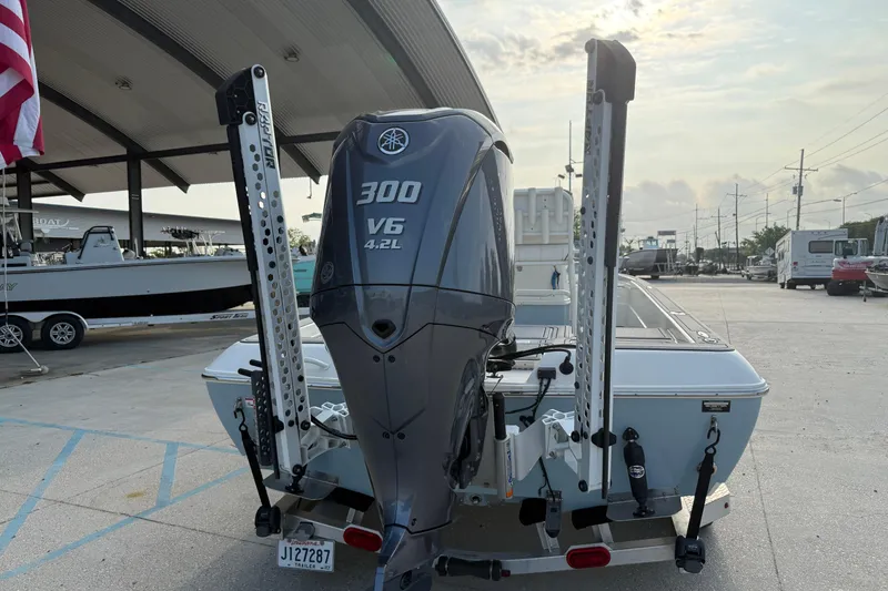 Slide: The Image of 2023 Skeeter SX240 boat with Yamaha 300 V6 engine at a marina. - 4