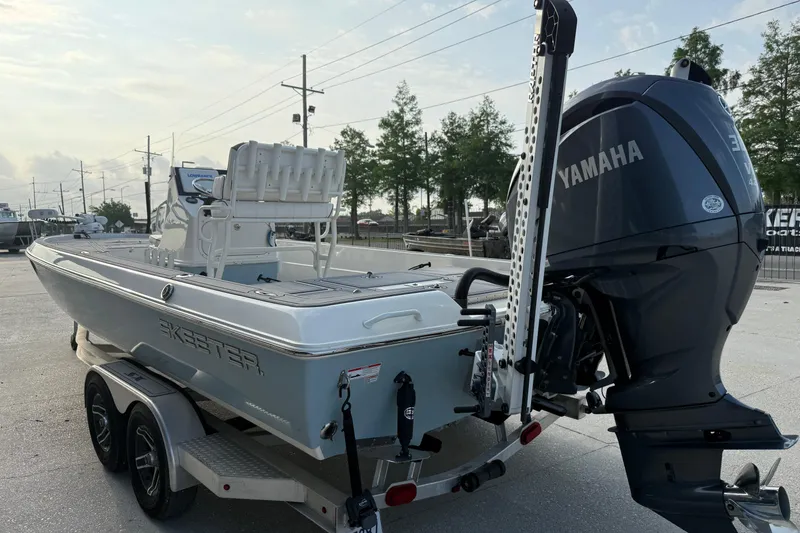 Slide: The Image of 2023 Skeeter SX240 boat with Yamaha engine on a trailer, parked outdoors. - 5