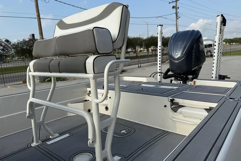 Slide: The Image of 2023 Skeeter SX240 boat with cushioned seating and powerful outboard motor. - 9