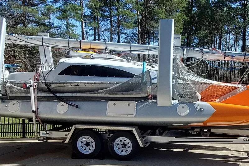 Slide: The Image of 2007 Farrier F-82R trimaran on trailer, surrounded by trees. - 3