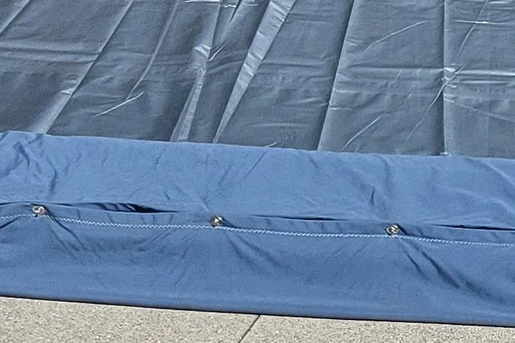 Slide: The Image of Sail from a 2007 Farrier F-82R boat, displayed on a blue tarp outdoors. - 32