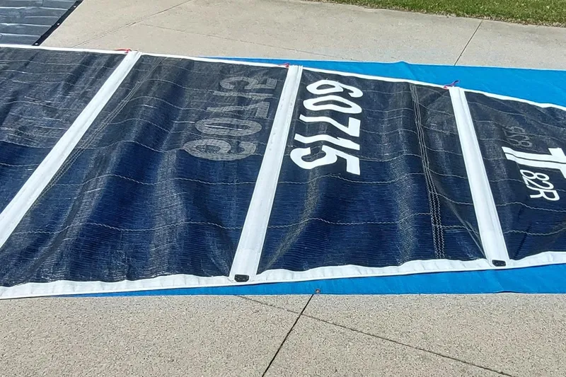 Slide: The Image of Sail from a 2007 Farrier F-82R boat, displayed on pavement. - 34