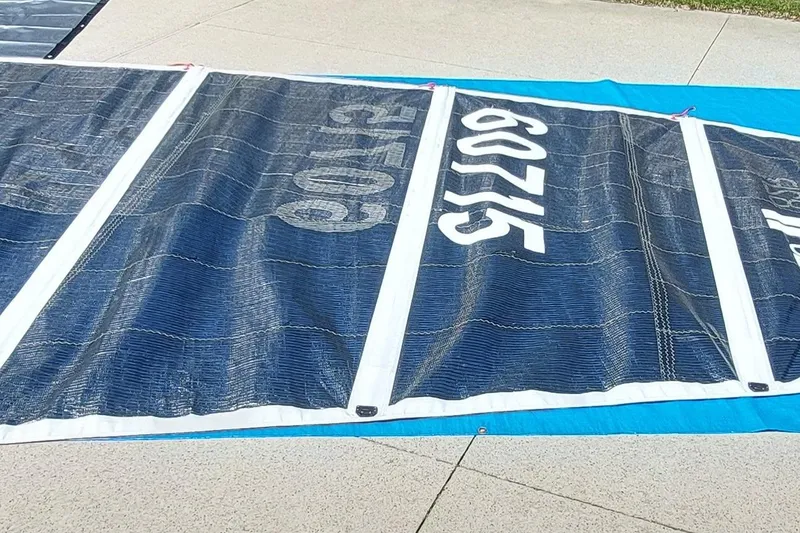 Slide: The Image of Sail from a 2007 Farrier F-82R boat, laid out on concrete. - 35