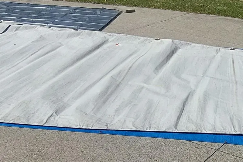 Slide: The Image of Sail from a 2007 Farrier F-82R boat laid out on a blue tarp. - 43