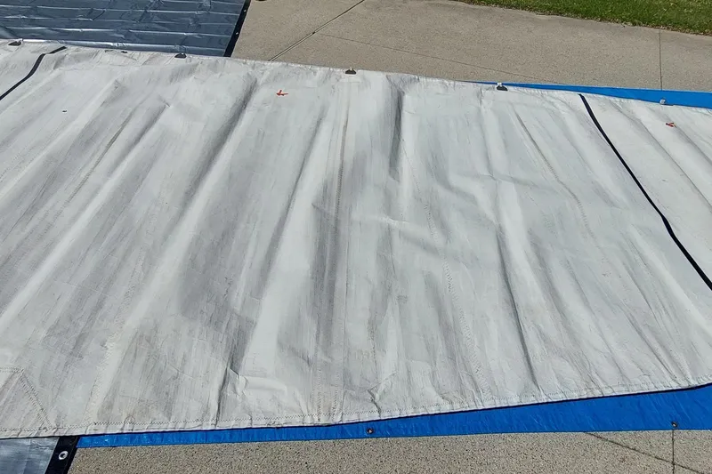 Slide: The Image of White tarp covering Farrier F-82R, 2007 model, on a sunny day. - 45