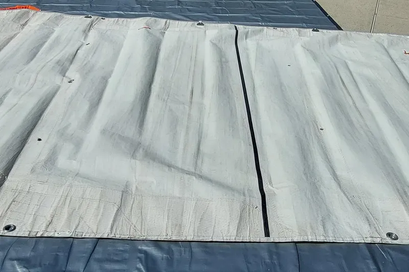 Slide: The Image of Rolled tarp with red straps on concrete, Farrier F-82R, 2007 model. - 46