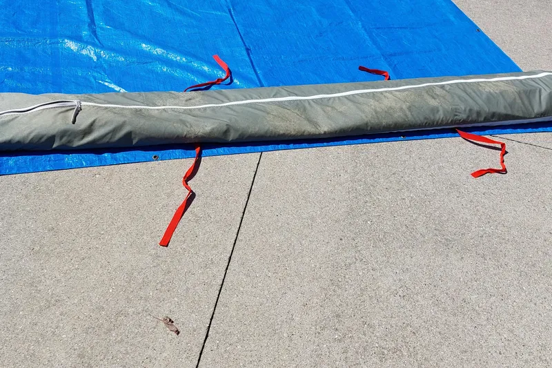 Slide: The Image of Sail from a 2007 Farrier F-82R boat, laid out on pavement. - 47