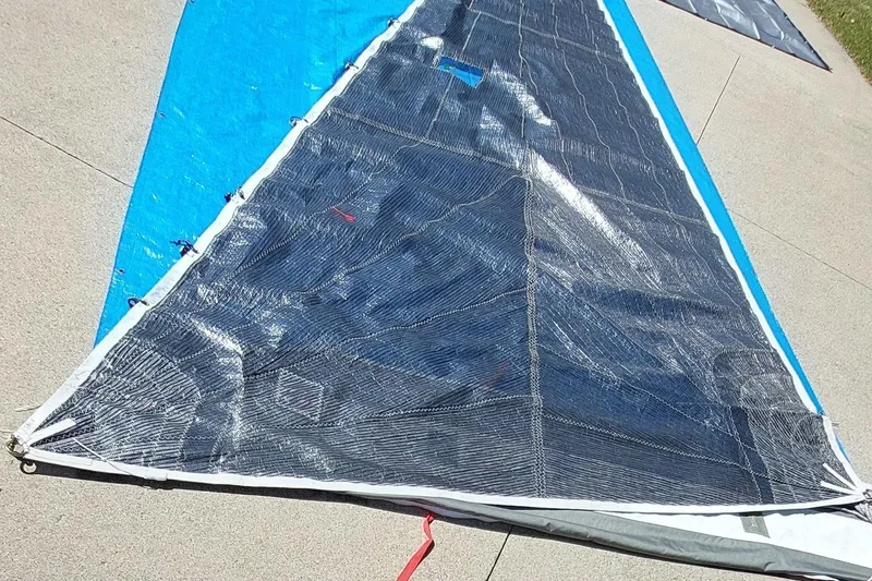 Slide: The Image of Sail laid out on pavement, Farrier F-82R model, 2007, showcasing intricate stitching. - 48