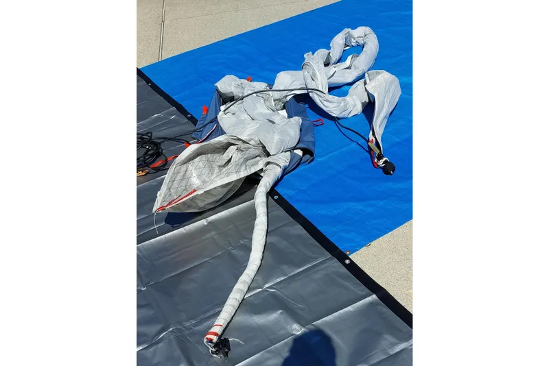 Slide: The Image of Gray bag with red "G" on blue tarp, Farrier F-82R, 2007 model. - 55