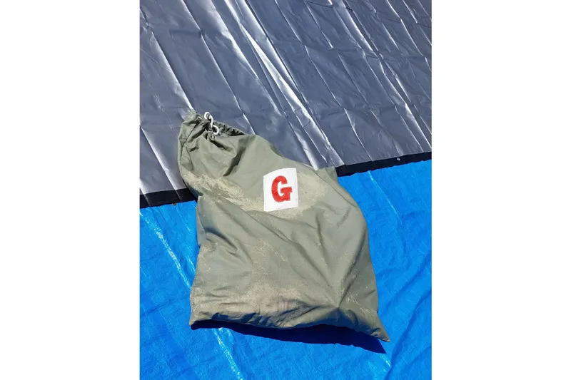 Slide: The Image of Deflated Farrier F-82R sail on blue tarp, 2007 model. - 56