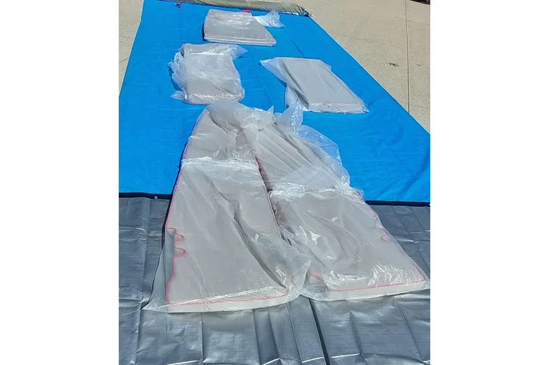 Slide: The Image of Plastic-wrapped Farrier F-82R parts on blue tarp, 2007 model. - 59