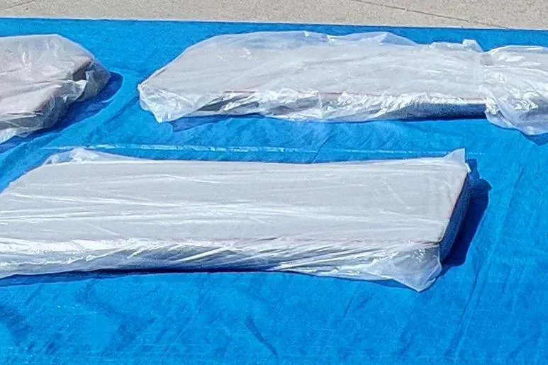 Slide: The Image of Cushions wrapped in plastic on a blue tarp, Farrier F-82R, 2007 model. - 60
