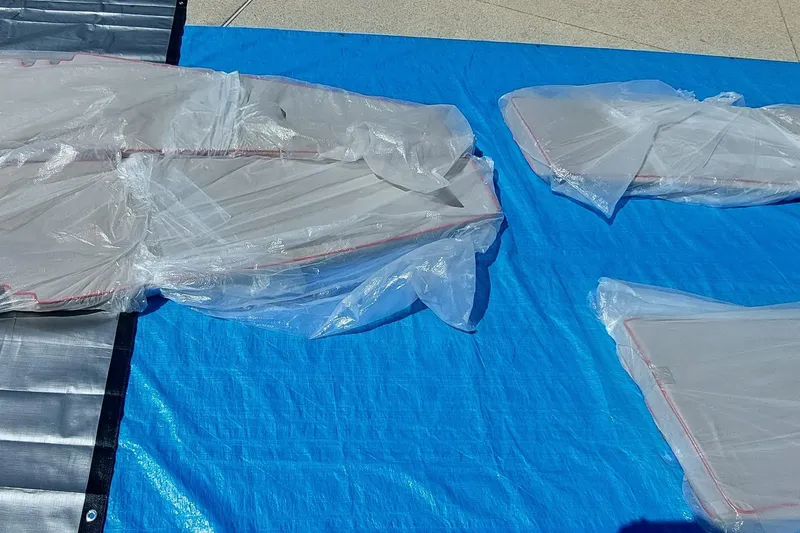 Slide: The Image of Plastic-wrapped Farrier F-82R parts on blue tarp, 2007 model. - 63