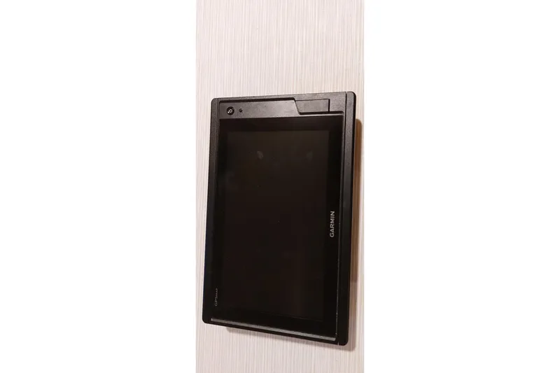 Slide: The Image of Wall-mounted Garmin device, Farrier F-82R model, 2007, on a light wood surface. - 66