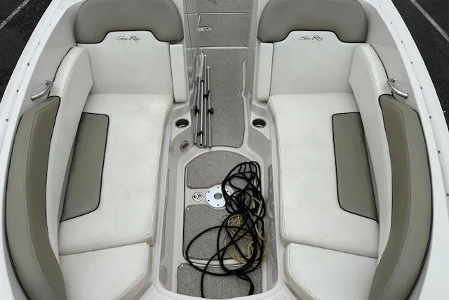 Slide: The Image of 2007 Sea Ray 260 Sundeck interior with beige seating and storage area. - 12