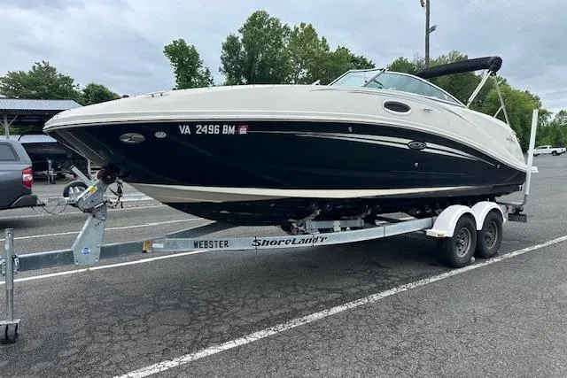 Slide: The Image of 2007 Sea Ray 260 Sundeck boat on trailer in parking lot. - 17
