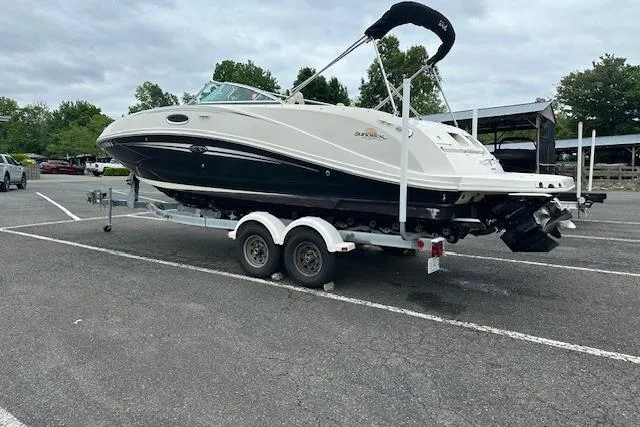 Slide: The Image of 2007 Sea Ray 260 Sundeck boat on trailer in parking lot, overcast sky. - 20