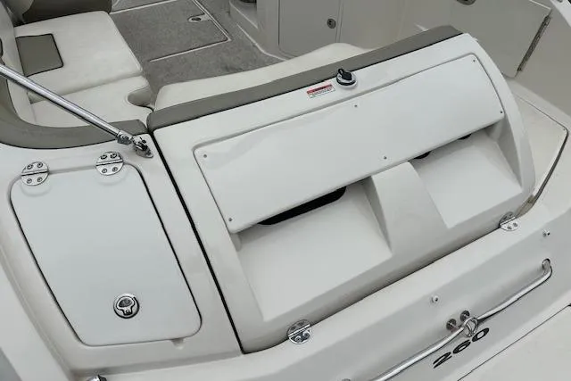 Slide: The Image of 2007 Sea Ray 260 Sundeck boat interior, featuring storage compartments and seating area. - 26
