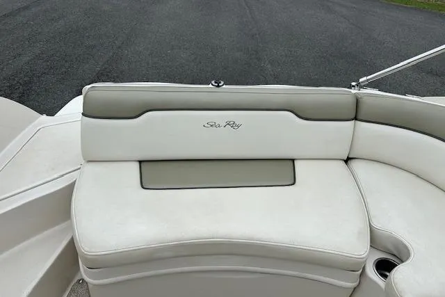 Slide: The Image of 2007 Sea Ray 260 Sundeck boat seat with logo, featuring white and gray upholstery. - 28