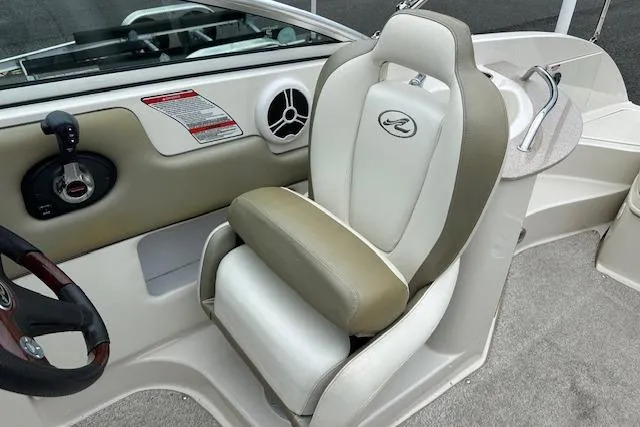 Slide: The Image of 2007 Sea Ray 260 Sundeck boat interior with beige and white captain's chair. - 4