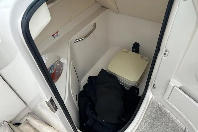 Slide: The Image of 2007 Sea Ray 260 Sundeck interior with portable toilet and storage area. - 9