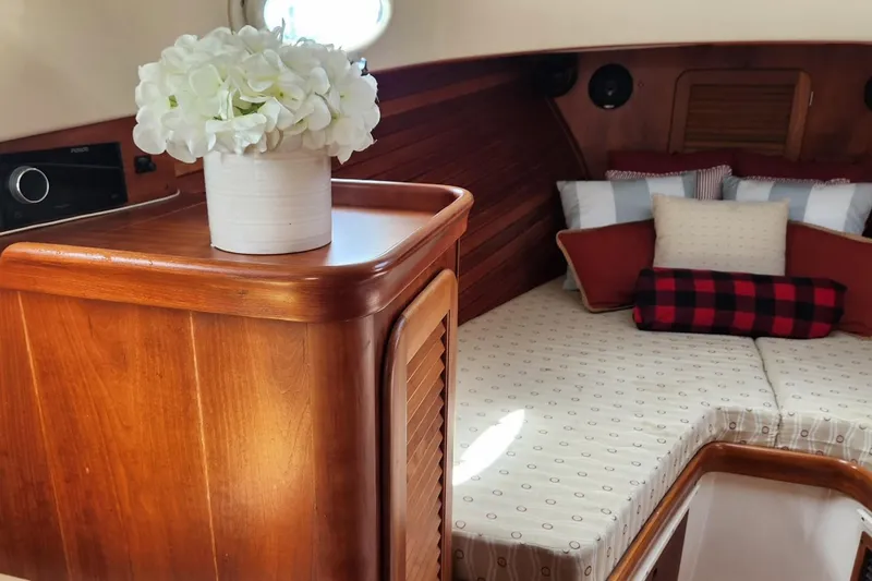Slide: The Image of 2003 Hinckley Picnic Boat EP interior with cozy bedding and floral decor. - 11