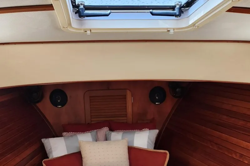 Slide: The Image of 2003 Hinckley Picnic Boat EP cabin interior with skylight and cozy bedding. - 13