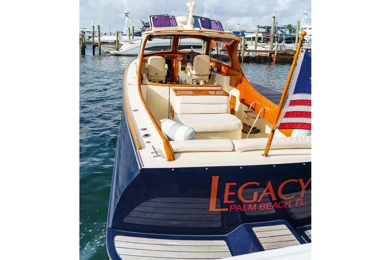 Slide: The Image of 2003 Hinckley Picnic Boat EP docked, featuring elegant design and American flag. - 17