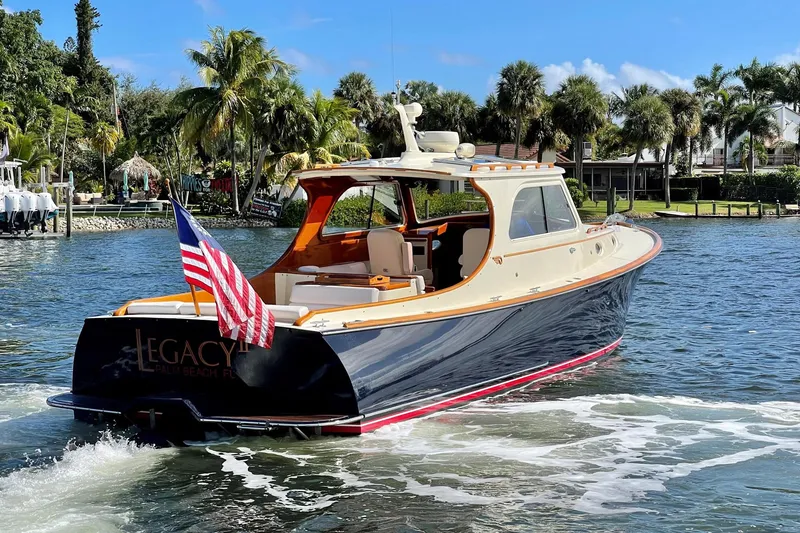 Slide: The Image of 2003 Hinckley Picnic Boat EP cruising on a sunny day with palm trees in the background. - 19