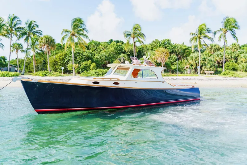 Slide: The Image of 2003 Hinckley Picnic Boat EP in tropical waters with palm trees in the background. - 3