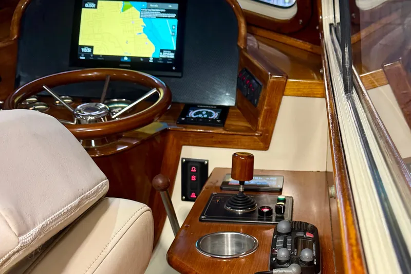 Slide: The Image of 2003 Hinckley Picnic Boat EP helm with navigation screen and controls. - 6