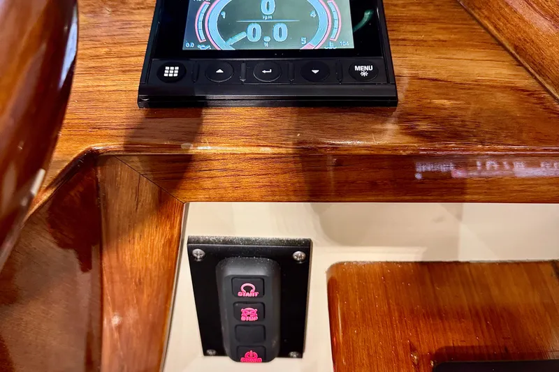Slide: The Image of Control panel of a 2003 Hinckley Picnic Boat EP with wooden dashboard. - 7