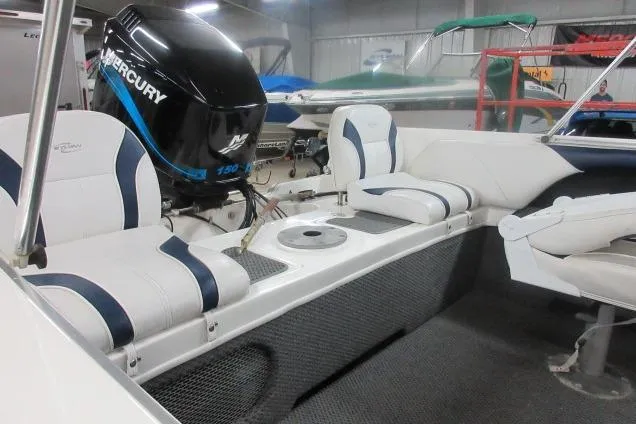 Slide: The Image of 2003 Sylvan V180 Viper OB boat interior with Mercury outboard motor and white seating. - 10