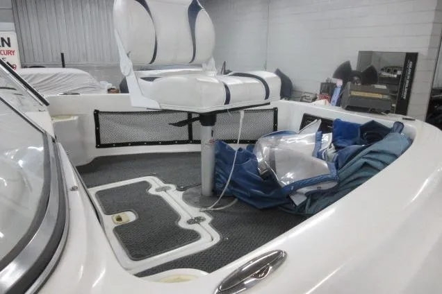 Slide: The Image of 2003 Sylvan V180 Viper OB boat interior with white seating and storage area. - 12