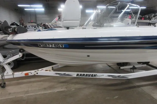 Slide: The Image of 2003 Sylvan V180 Viper OB boat on Karavan trailer in indoor showroom. - 5