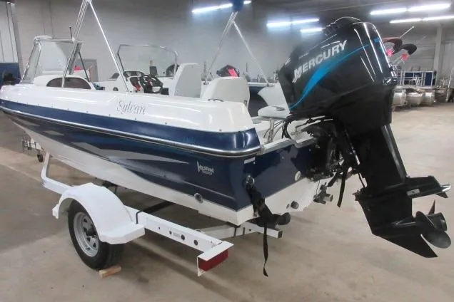 Slide: The Image of 2003 Sylvan V180 Viper OB boat with Mercury outboard motor on trailer in indoor setting. - 6