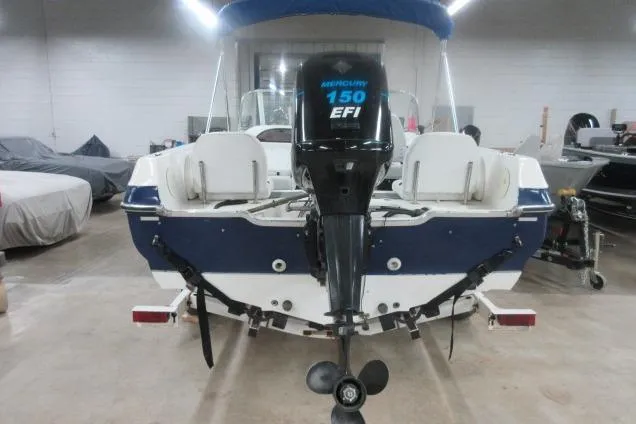 Slide: The Image of 2003 Sylvan V180 Viper OB boat with Mercury 150 EFI engine in a garage setting. - 7