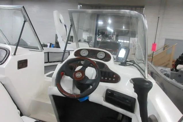 Slide: The Image of 2003 Sylvan V180 Viper OB boat dashboard with steering wheel and gauges. - 9