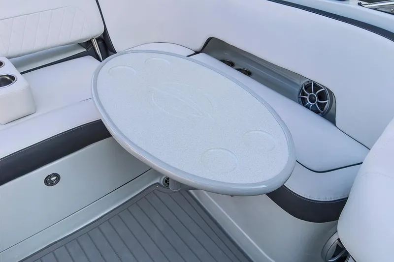 Slide: The Image of 2024 Crownline Eclipse E235 SURF boat interior with table and seating area. - 10