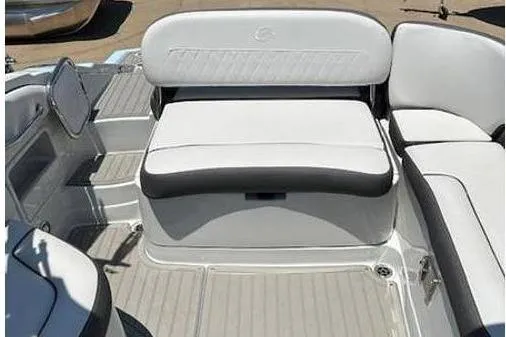 Slide: The Image of 2024 Crownline Eclipse E235 SURF boat interior with white seating and sleek design. - 11