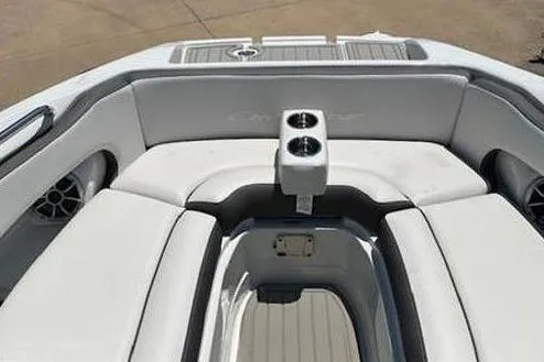 Slide: The Image of 2024 Crownline Eclipse E235 SURF boat interior with cushioned seating and cup holders. - 5