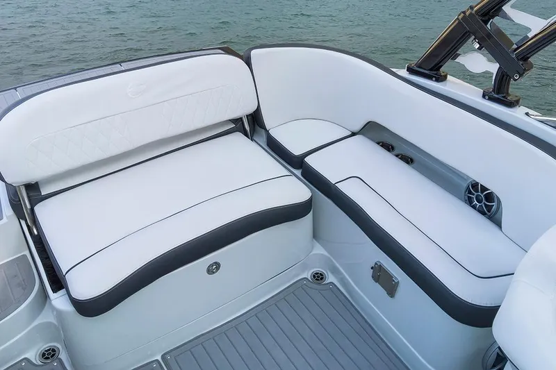 Slide: The Image of 2024 Crownline Eclipse E235 SURF boat interior with white cushioned seating. - 9