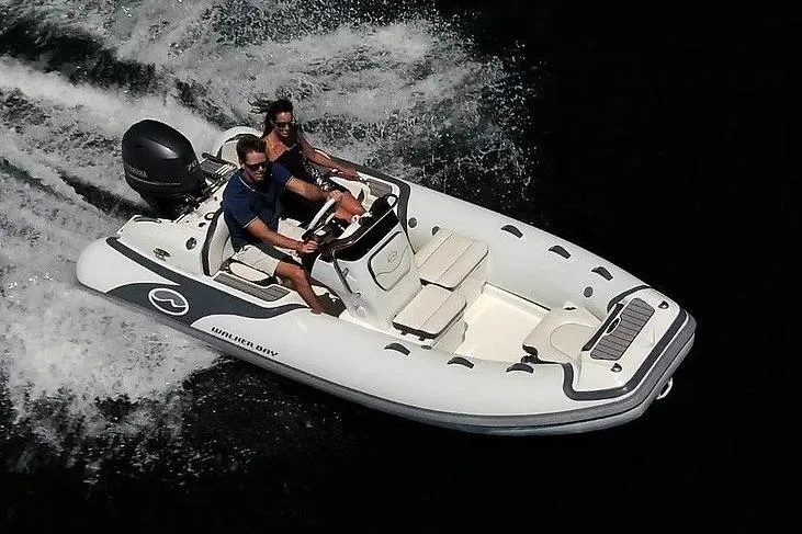 Slide: The Image of Manufacturer Provided Image: 2022 Walker Bay Venture 14 boat cruising on water with two passengers. - 3