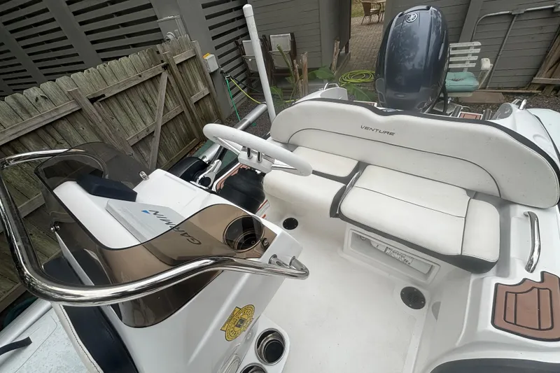 Slide: The Image of 2022 Walker Bay Venture 14 boat interior with seating and steering console. - 6
