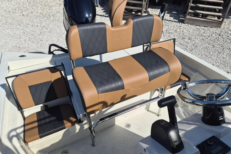 Slide: The Image of 2026 Xpress H20B Bay boat interior with tan and black seating, steering wheel visible. - 10