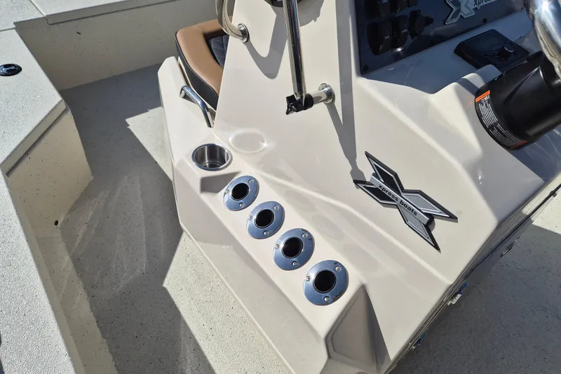 Slide: The Image of 2026 Xpress H20B Bay boat console with cup holders and logo detail. - 12
